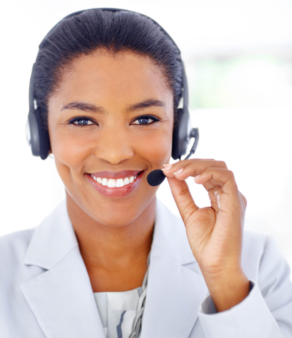 Portrait of a pretty call centre agent wearing a headset smiling at you